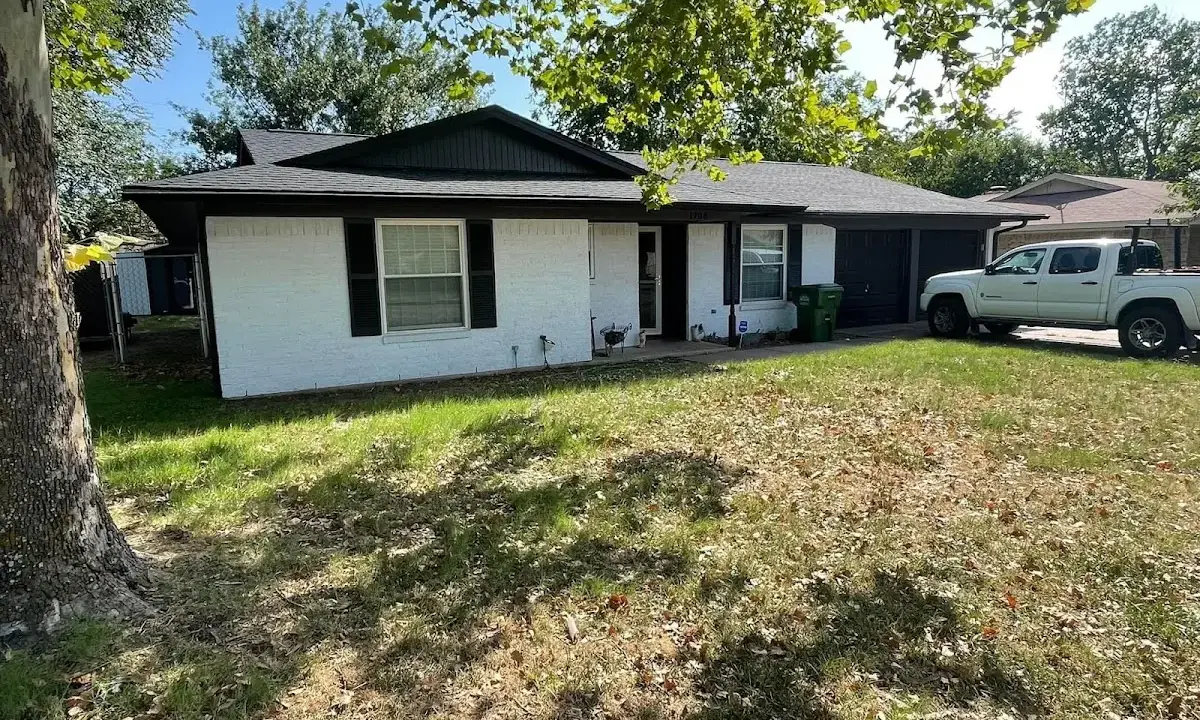Professional roofing crew working on a residential roof in Grand Rapids